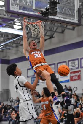 Caden Scarborough scores two of his 10 points on this thunderous dunk in Harmony's 48-46 District 7A-5 championship game win Friday over Lake Nona. PHOTO/KATIE WILLIAMS