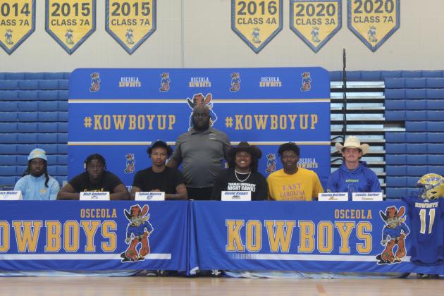 Six members of Osceola High's state semifinals football teams signed their college scholarships on Wednesday. PHOTO/KEN JACKSON