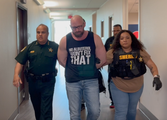 Sheriff's officials lead Aaron Meehan, 40, into custody Tuesday after his arrest on child molestation charges.