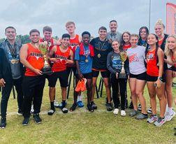 Members of the victorious, and defending, OBC track champion Harmony Longhorns team show off the trophies. PHOTO/KATIE WHITT WILLIAMS