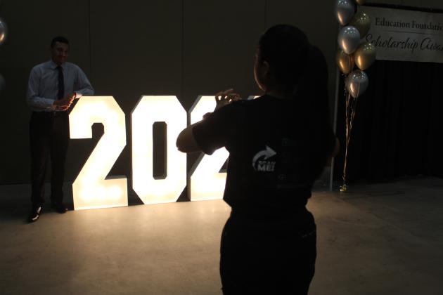 Students take photos at Wednesday's Education Foundation Scholarship Awards ceremony. PHOTO/KEN JACKSON