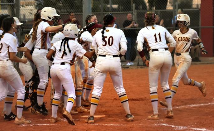 St. Cloud greets Garcelyn Watford after she homered in the second inning of Friday's OBC championship game. PHOTO/KATIE WHITT WILLIAMS