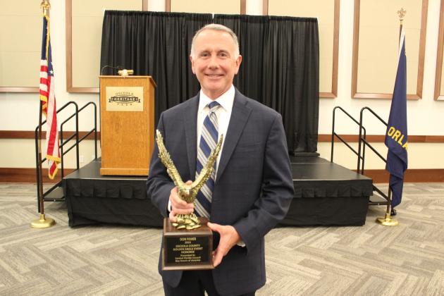 Osceola County Manager Don Fisher was awarded the service awarded by the Boy Scouts of the Central Florida Council Tuesday. PHOTO/KEN JACKSON