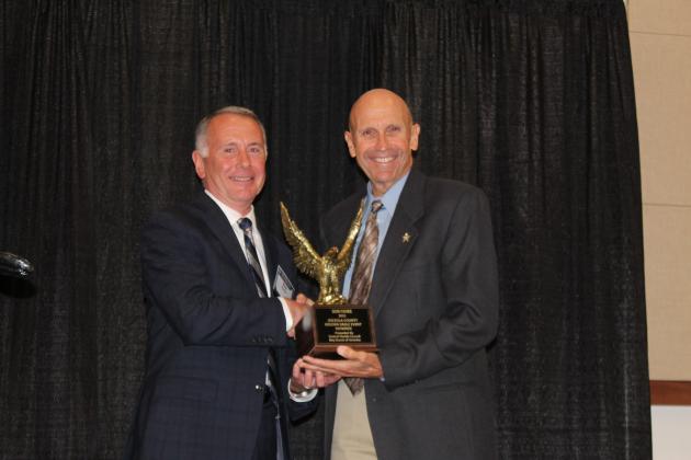 Osceola County Manager Don Fisher (left), pictured with Golden Eagle banquet emcee Bob Hansell, was awarded the service awarded by the Boy Scouts of the Central Florida Council Tuesday. PHOTO/KEN JACKSON