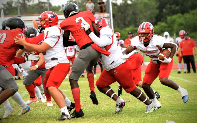 Poinciana's Akeem Knox runs behind his line in Friday's 28-0 spring game win at Gateway. PHOTO/KATIE WILLIAMS
