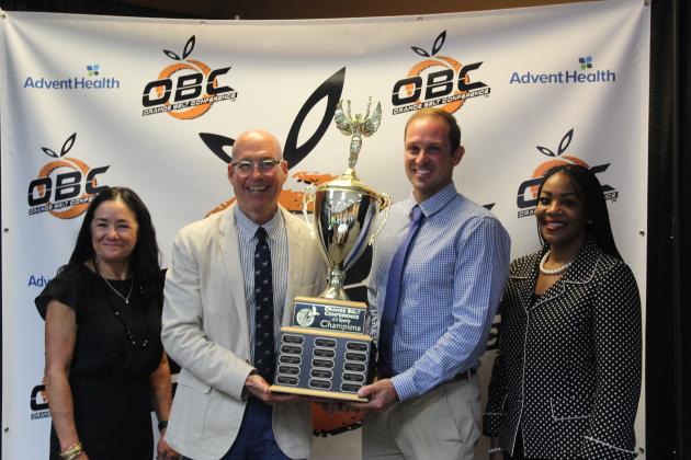 Harmony Principal James Hickey (left with trophy) and Longhorns Athletic Director Dan Kerr accepted Harmony's OBC All-Sports Trophy. PHOTO/KEN JACKSON