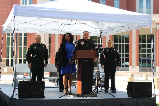 Alieah Hemans prepares to sing the National Anthem as the Osceola County Sheriff Marcos Lopez, St. Cloud Police Chief Douglas and Kissimmee Chief Betty Holland look on.  PHOTO/TERRY LLOYD