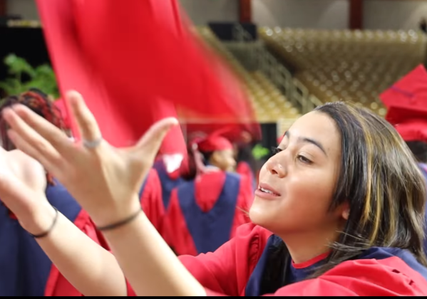 A Poinciana High grad catches her cap after a post-announcement celebratory toss. PHOTO/OSCEOLA COUNTY SCHOOL DISTRICT