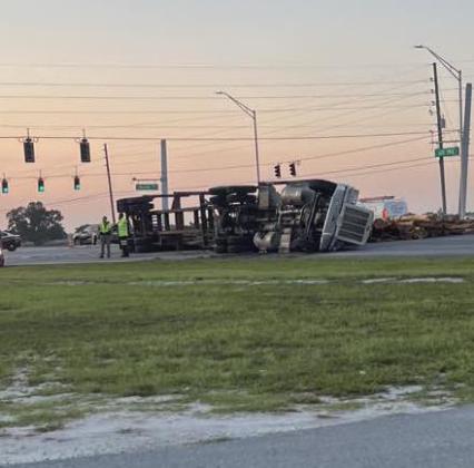 An overturned logging truck at Nova Road has the westbound lanes of 192 closed, although traffic is able to get through cutting through the BP gas station at the corner. PHOTO/TAMMY JOHNSON VIA FACEBOOK