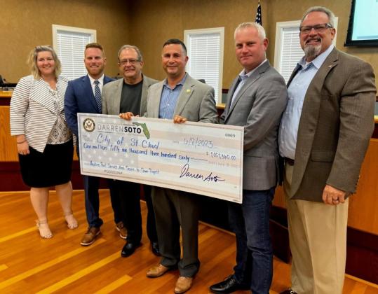 U.S. Rep. Darren Soto, D-Kissimmee, attended Thursday's St. Cloud City Council meeting to present a check for $1.05 million, funding he helped secure for the city to get Hopkins Park area residents off septic systems and onto the public water/sewer system. PHOTO/CITY OF ST. CLOUD