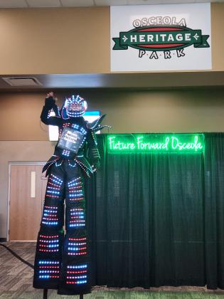 The new "Future Forward Osceola" tagline got a bit of visual stilt-walk help at Thursday's event. PHOTO/KEN JACKSON