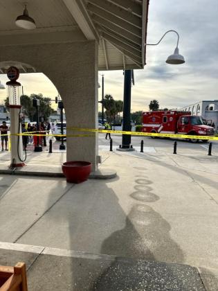 Authorities respond to Sunday's fatal crash at Broadway and Neptune Road in downtown Kissimmee Sunday morning as onlookers gather near the Kissimmee Main Street office. PHOTO/DIANA MARRERO-PINTO