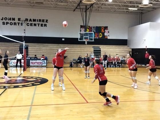 Kailyn Paulino (15) sets a ball to teammate Ivana Reyes (3).  PHOTO/J. DANIEL PEARSON