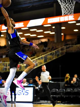 Trevelin Queen dunks for two of his 21 points in the Osceola Magic's home-opening victory Thursday at the Silver Spurs Arena. PHOTO/KATIE WILLIAMS