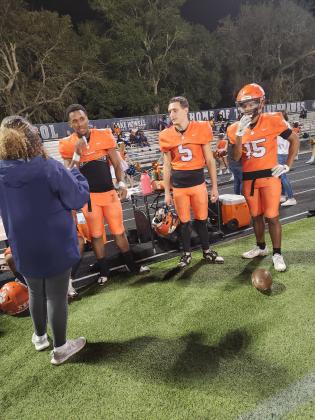 Tohopekaliga seniors Churandy Duval, Julian Nasco and Jayden Oliver celebrate on the sideline near the end of Wednesday's victory. PHOTO/KEN JACKSON