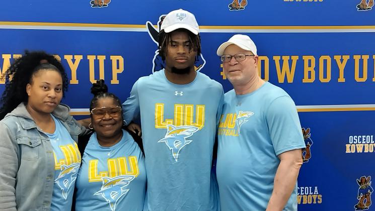 Osceola's Jalen Bell with his family at Friday's signing with FCS school Long Island. PHOTO/J. DANIEL PEARSON