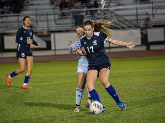 Celebration's Jenna Mitchell fights for the ball during the Storm's District 7A-9 championship match Tuesday at Harmony. PHOTO/MARIO CASAMALHUAPA