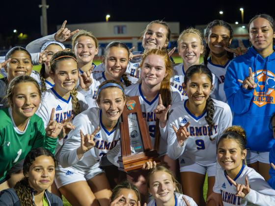 The Harmony Longhorns proudly display the Class 7A, District 9 trophy they won with a 1-0 win over Celebration on Tuesday night. PHOTO/MARIO CASAMALHUAPA