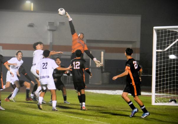 Tohopekaliga goalie Jason Barrientos turns away a shot early in Friday's Orange Belt Conference boys soccer championship game. PHOTO/KATIE WILLIAMS