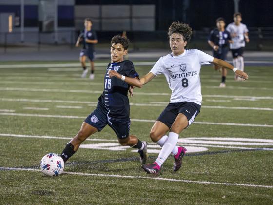 Celebration's Euclides Sebastiani and Olympic Heights' Benjamin Labrador fight for a ball in Friday's playoff game, won by the Storm in penalty kicks. PHOTO/MARIO CASAMALHUAPA