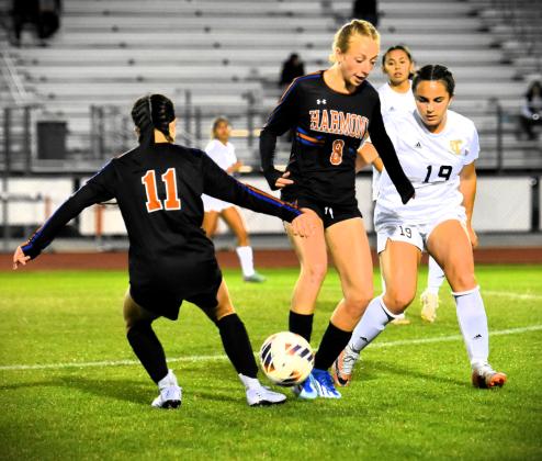 Harmony's Ashlyn Florio (8) and Jordyn Frost (11) work to get possession of the ball in Tuesday's Class 7A regional quarterfinal playoff game against Treasure Coast. PHOTO/KATIE WILLIAMS