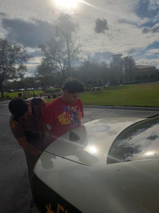 A Florida Highway Patrol trooper takes Kais Mahmoud Kaheel, 28, into custody Thursday after a chase through Orange and Osceola counties. PHOTO/FLORIDA HIGHWAY PATROL