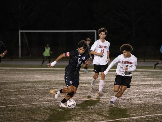 Celebration's Jose D'Lima fights off a pair of Palm Beach Central defenders in Tuesday's regional quarterfinal playoff game, a 2-0 Storm win.PHOTO/MARIO CASAMALHUAPA