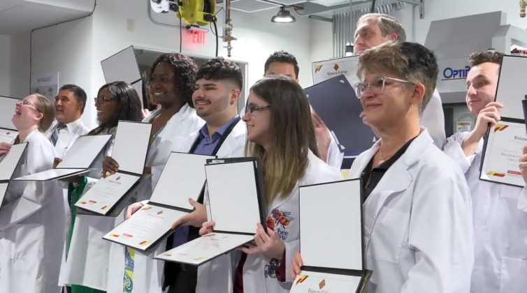Thursday, the same day Valencia College dedicated its Precision Optics Lab and a partnership with Lockheed Martin, 14 graduates earned their certifications -- and white lab coats. PHOTO/VALENCIA COLLEGE