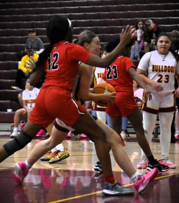 St. Cloud's Emily Lockey fights through a pair of Kathleen defenders in Friday's District 6A-7 championship, a 53-40 Bulldogs win. PHOTO/KATIE WILLIAMS