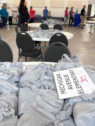 St. Cloud Cares packages hundreds of meal packs each week to go to needy students for the weekend. PHOTO/DEBBIE DANIELS