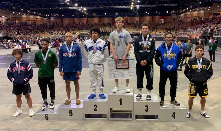 Anderson Heap on top of, well, the heap, collecting his gold medal for winning the Class 3A 150-pound state championship Saturday. PHOTO/KATIE WILLIAMS