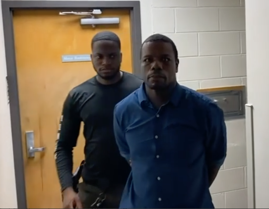 Kenyada Emanuel Jacobs, a habitual felonious offender, is led to jail by an Osceola County Sheriff's deputy Wednesday in connection with a Monday bank robbery in Poinciana. PHOTO/OSCEOLA SHERIFF'S OFFICE