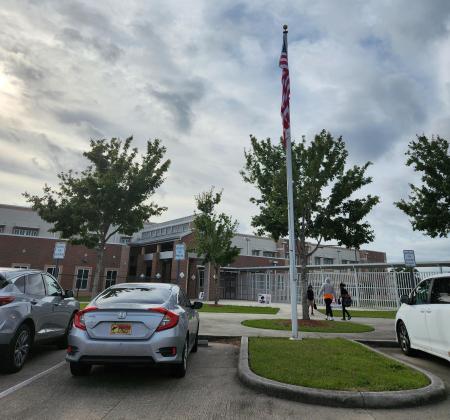 The American and Florida state flags fly over Highlands Elementary School in Kissimmee Wednesday. A resolution brought forward at Tuesday's School Board meeting would those flags couldn't be flown with any political action flags. PHOTO/KEN JACKSON