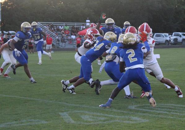 Osceola's defense swarmed Thursday, here bottling up an Edgewater tackler, as it shut out the Eagles and DeLand Bulldogs in two halves of spring football. PHOTO/KEN JACKSON