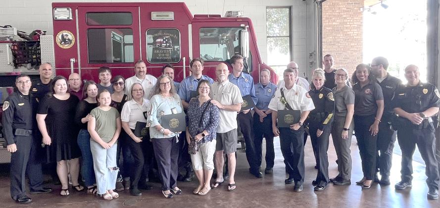 The Bowers family, pictured with the first responders who saved Bill’s life, is grateful for the work of Kissimmee first responders. PHOTO/DEBBIE DANIEL