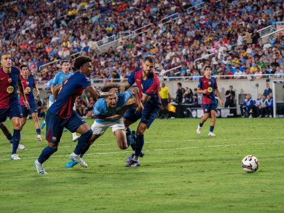 The action got rough and tumble Tuesday at Camping World Stadium between FC Barcelona and Manchester City. PHOTO/MARIO CASAMALHUAPA