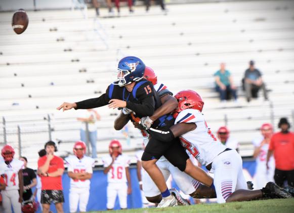 Poinciana Jakobe Hines gets to Harmony quarterback Landon Hayes in Friday's 36-5 Eagles victory. PHOTO/KATIE WILLIAMS