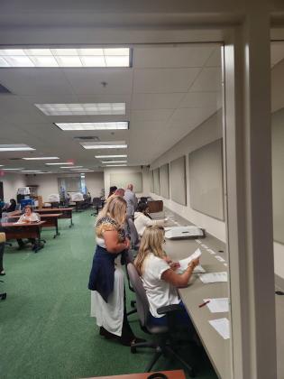Supervisor of Elections officials Friday count ballots that were under or over-counted in Tuesday's primary for the Kissimmee mayor's race. PHOTO/KEN JACKSON