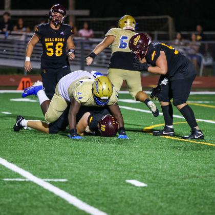 That kind of night: Osceola's defensive lineman Amier Clarke sacks St. Cloud quarterback Logan King in Friday's 56-6 Kowboys victory. PHOTO/TAYLOR MCFEE