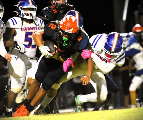 Tohopekaliga's Jaxson Hardnett runs for some tough yards in Wednesday's 14-9 district win over Harmony. PHOTO/KATIE WILLIAMS