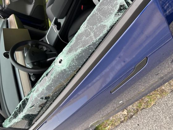 Bullet holes in the driver's door and side window of a blue Tesla which was involved in a road rage incident on northbound Florida's Turnpike just leaving Osceola County. PHOTOS/FHP
