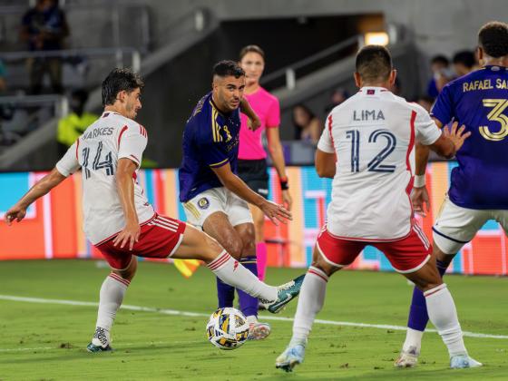 Orlando City's Martin Ojeda splits two New England players in the Lions' 3-0 win Saturday over the New England Revolution. PHOTO/MARIO CASAMALHUAPA