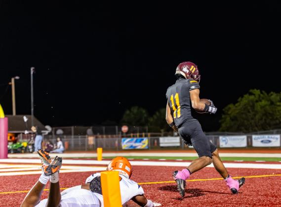 St. Cloud's Alex Springs rolls into the end zone for one of his three scores.  PHOTO/TAYLOR MCFEE
