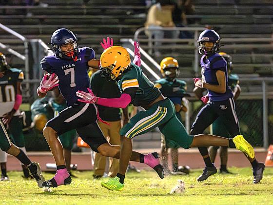 Celebration's Jayden McNeal avoids Liberty tacklers Friday in the Storm's 35-8 win over Liberty. PHOTO/MARIO CASAMALHUAPA