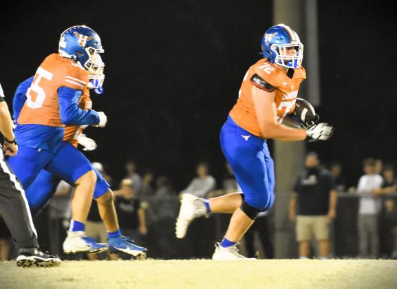 Big guy alert: Harmony's Wyatt Loeding gets the ball in Friday's rivalry game. PHOTO/KATIE WILLIAMS