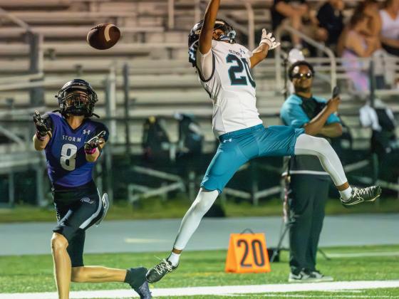 Celebration's Evan Couch (8) tries to make the catch Tuesday despite Olympia defender Keyshaun Marcelus' best efforts. The Titans pulled out the 17-9 win Tuesday. PHOTO/MARIO CASAMALHUAPA