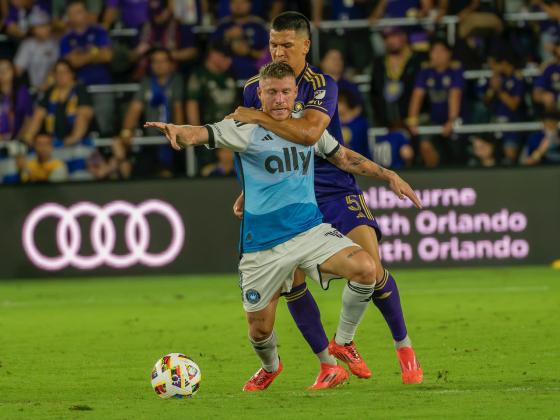 Charlotte's Pep Biel is fouled by Orlando's Cesar Araujo, showing the intense physical nature of Saturday's match. PHOTO/MARIO CASAMALHUAPA