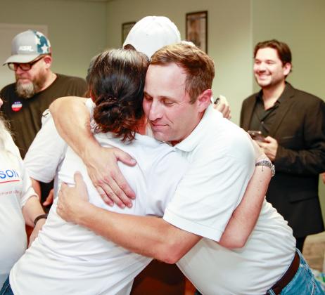 Chris Robertson shares a hug Tuesday night after the relief of winning the mayoral race washed over him. PHOTO/TAYLOR MCFEE
