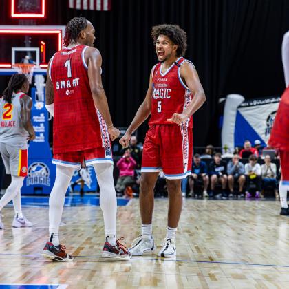 Javonte Smart (1) and Ethan Thompson (5) have that winning feeling Friday for the Osceola Magic -- must be those special Puerto Rican Heritage Night uniforms. Or maybe it was the 115-107 victory. PHOTO/TAYLOR MCFEE