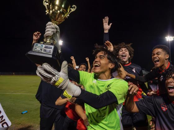 Gateway Mateo Chavez lifts the OBC boys soccer championship trophy. The senior goalkeeper blocked 1 penalty during the game and 2 penalty kicks during the penalty shootout.  PHOTO/MARIO CASAMALHUAPA